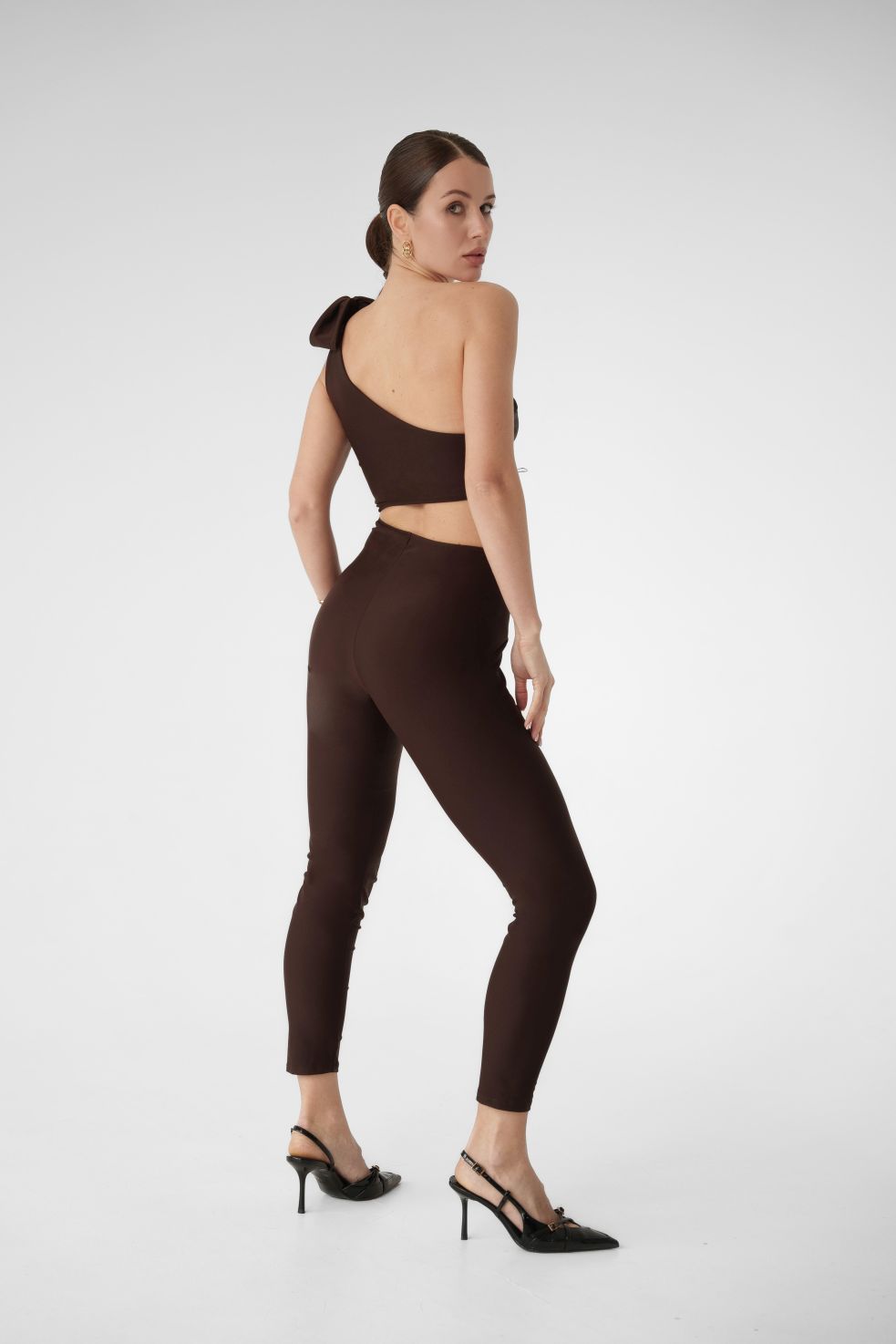 Back view of Dominica jumpsuit – chocolate brown outfit with one-shoulder design