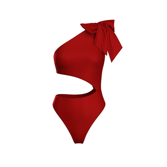 Model wearing Dominica red one-shoulder cut-out swimsuit with high-leg design and bow tie